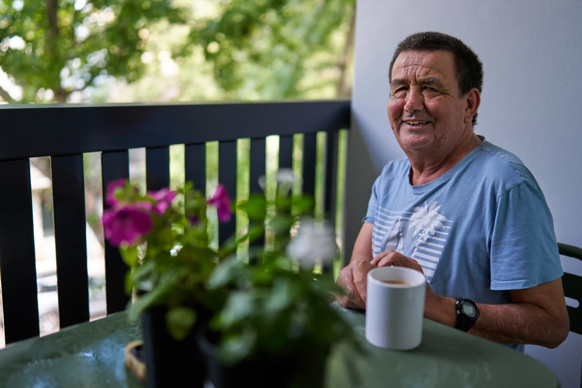 A member enjoying a morning coffee on the balcony of his own apartment at his Vertical Village.
