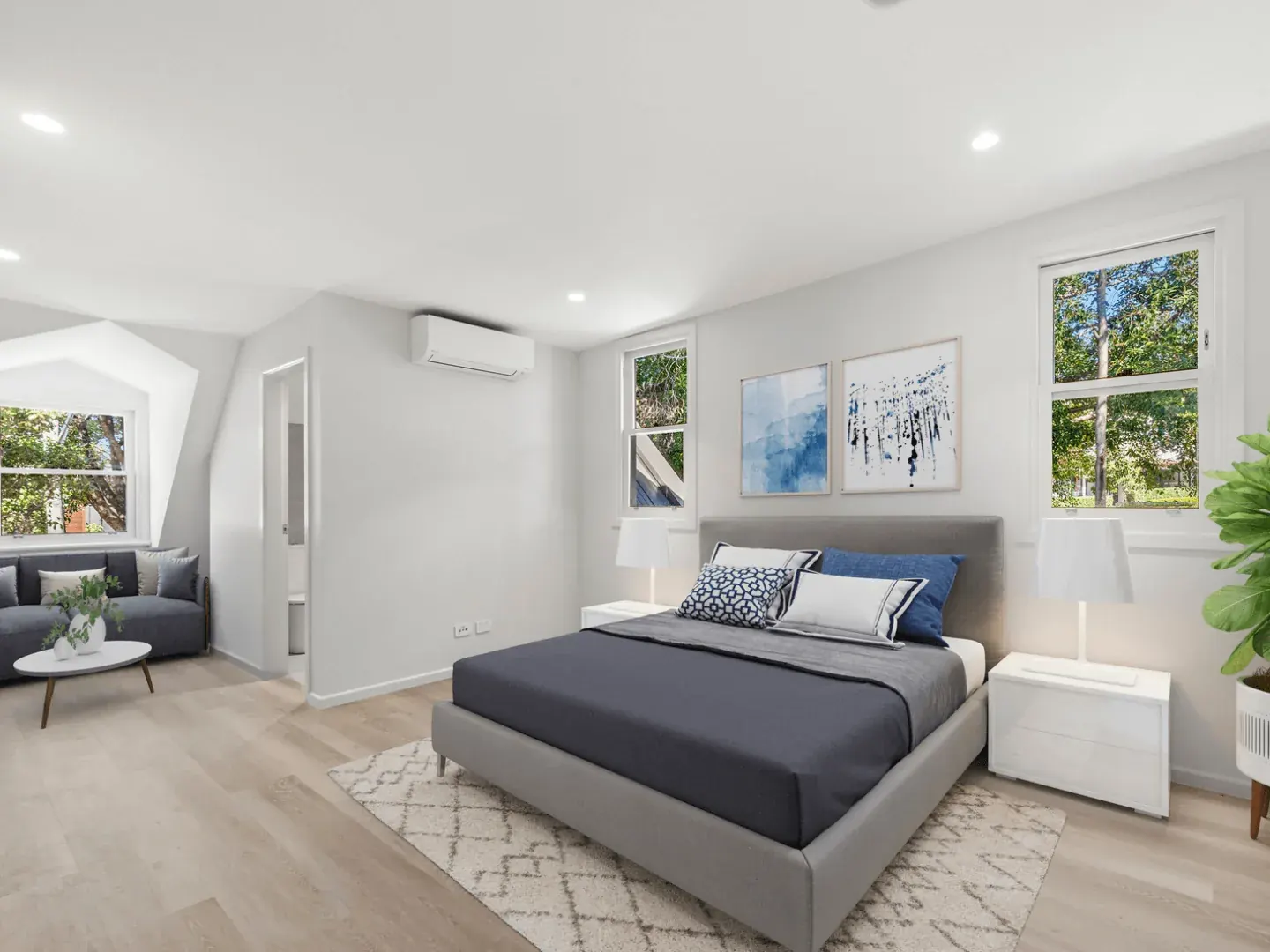 a bedroom at Erskineville with a sofa and a leafy view from two windows