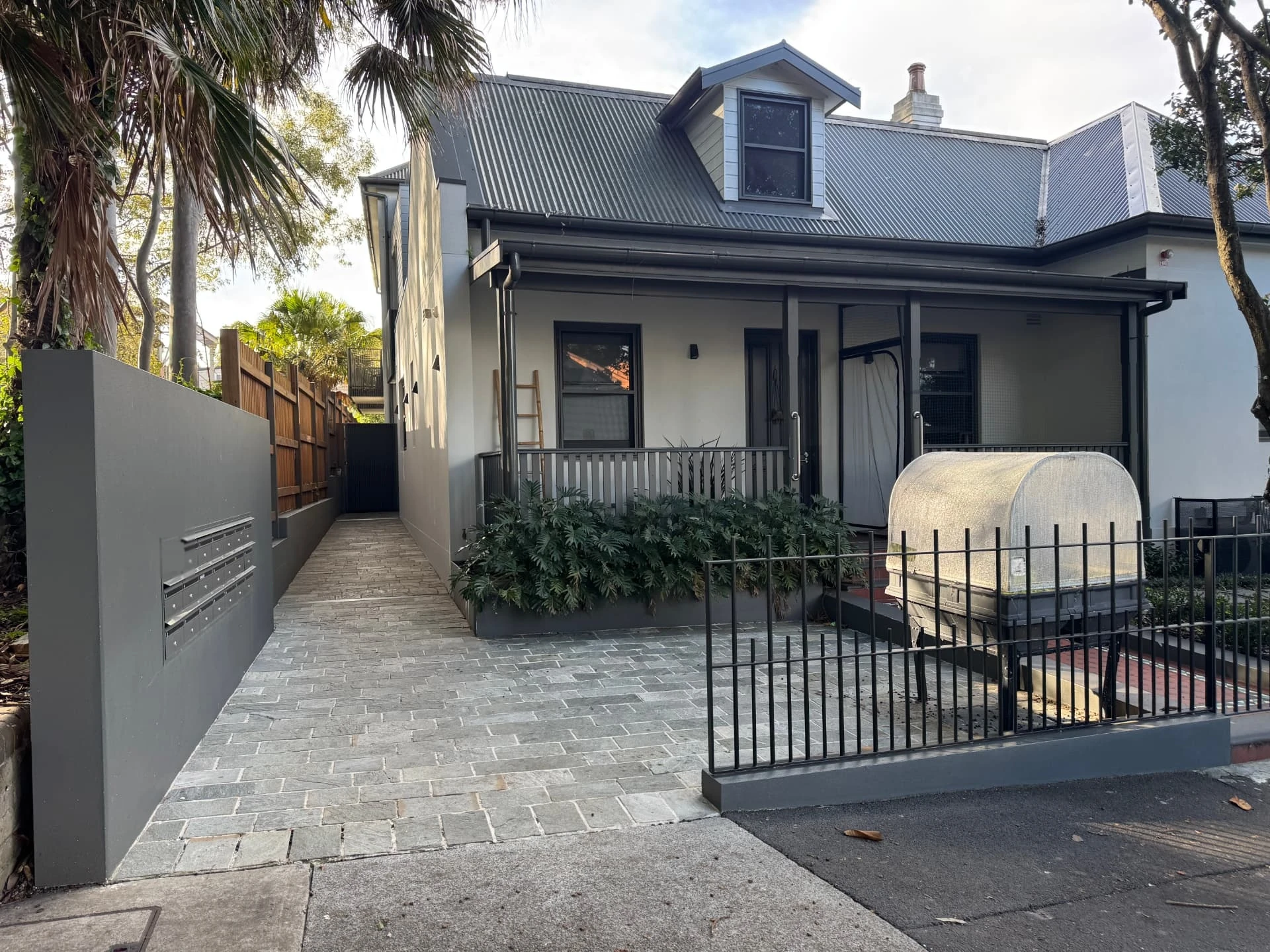 the front of the Erskineville village, a cottage frontage with a verandah and paved entry path