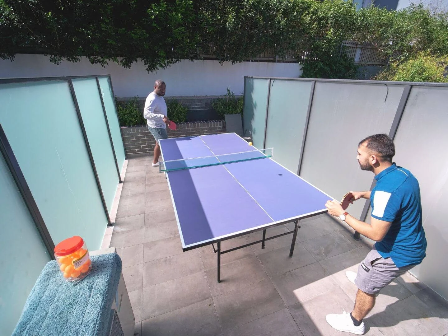 neighbours playing table tennis in the village courtyard at Petersham