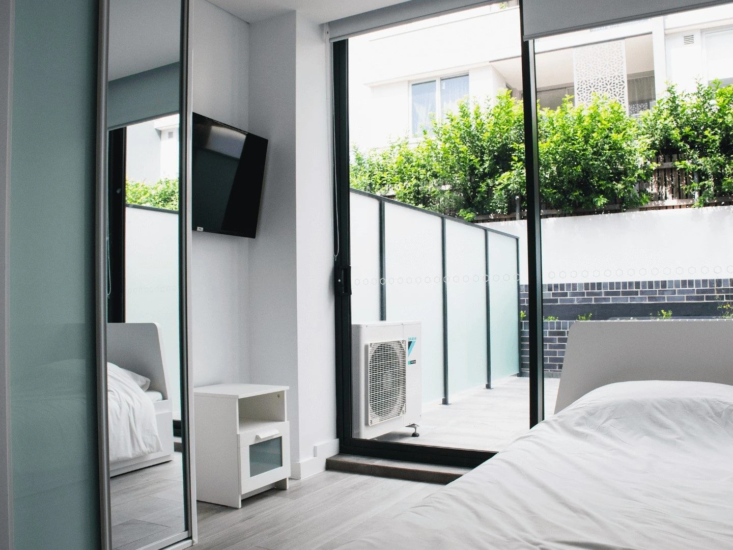 a second view of a studio at Petersham, opening onto a planted courtyard