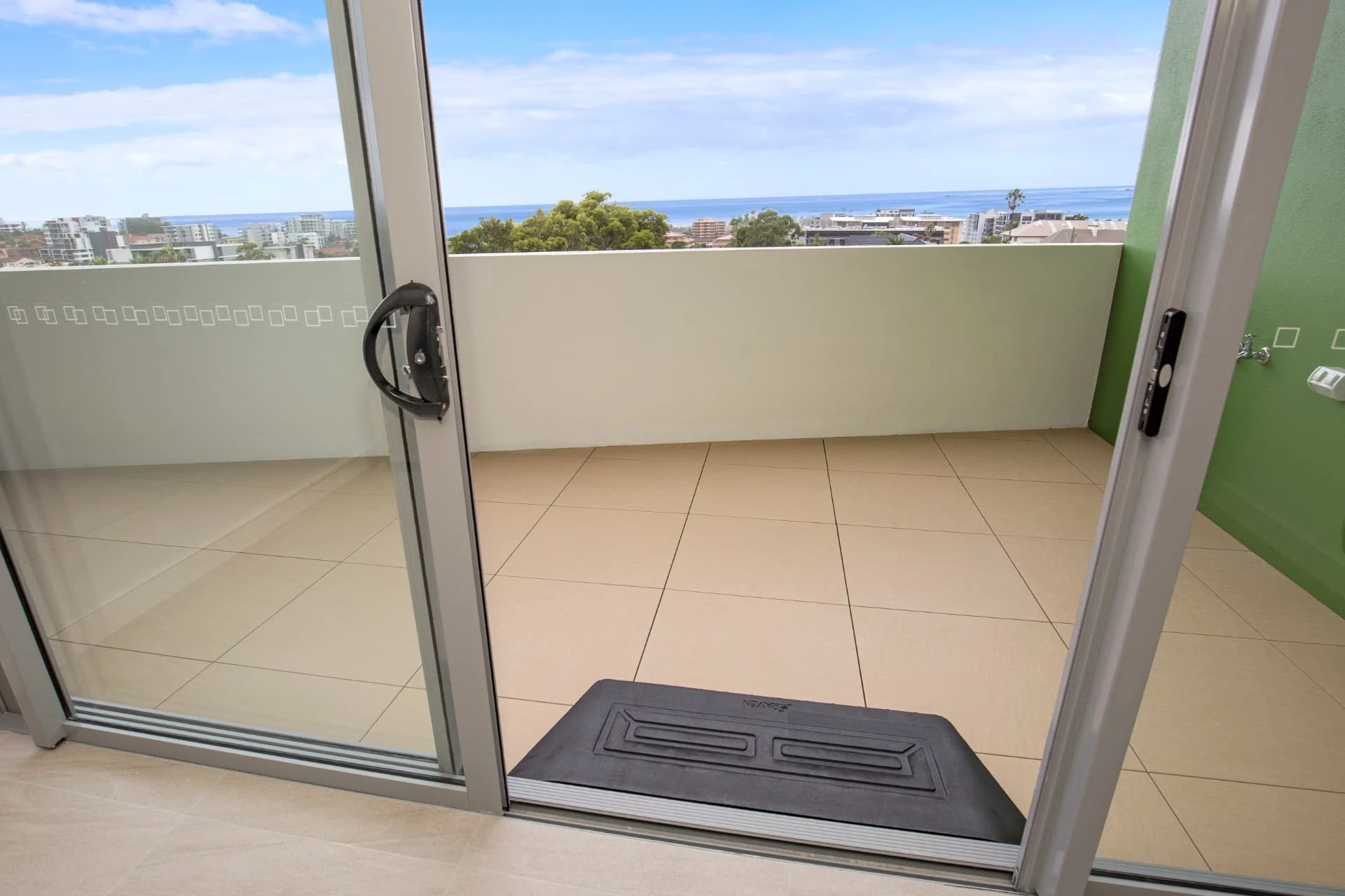 a level entry sliding door from an apartment out to a balcony at Wollongong