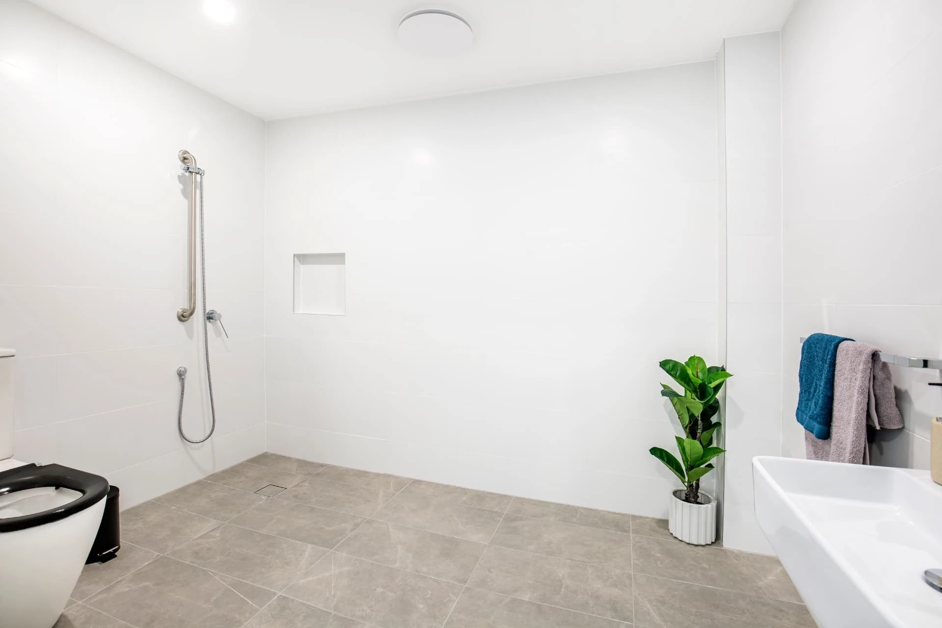an accessible bathroom with a level entry shower at Wollongong